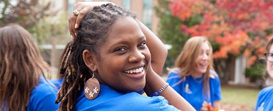 Smiling student in focus among group